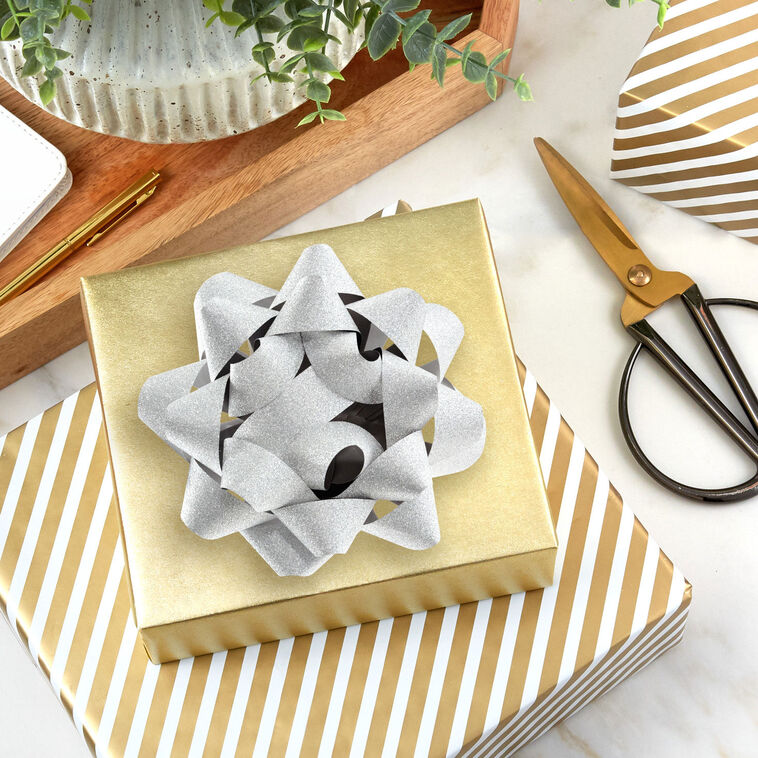 Hallmark silver gift bow with glitter finish and 21 textured loops on a white background.
