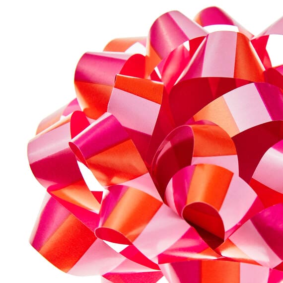 Pink and coral striped recyclable gift bow with self-adhesive backing, 4.6 inches diameter.

