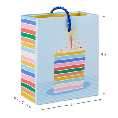 Mini gift bag with colorful layered cake slice design, gold foil accents, and pale blue background with twisted cord handles.

