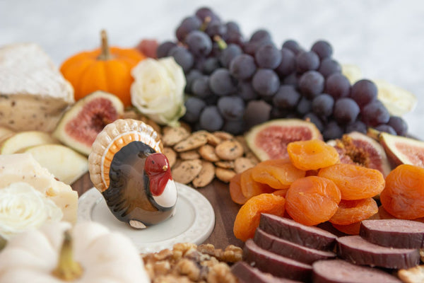Nora Fleming turkey-shaped mini with festive colors; a charming addition to Thanksgiving table decor; hand wash only.

