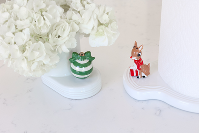 Official Rudolph the Red-Nosed Reindeer mini from Nora Fleming, featuring Santa’s famous reindeer with a red nose for festiv
