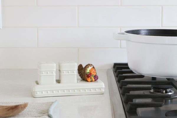 A ceramic mini featuring autumn harvest elements like pumpkins and leaves, perfect for Thanksgiving décor.

