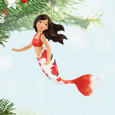 Hallmark Keepsake mermaid ornament with red and black iridescent tail, brunette hair, and white top in floating holiday pose.