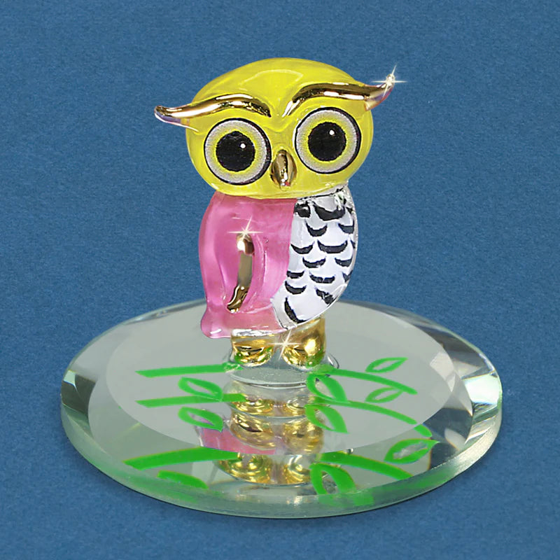 Handcrafted glass owlet figurine with 22Kt gold accents, displayed on a beveled glass mirror.