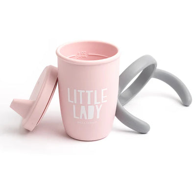 Bella Tunno Little Lady Happy Sippy Cup made of durable food-safe silicone with a soft spout, easy-grip handles, and a grow-with-me design to support your child's development.