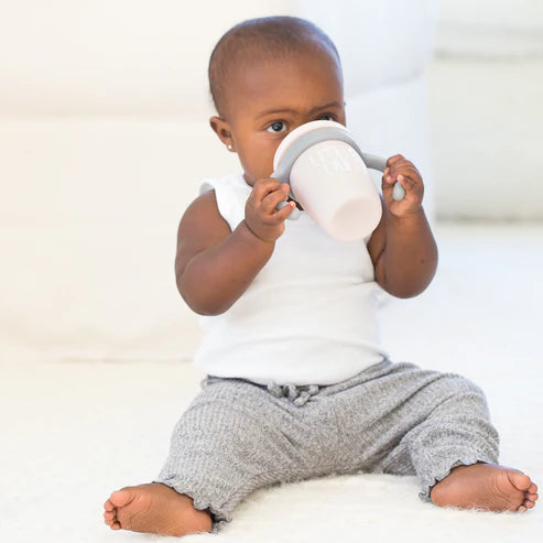 Bella Tunno Little Lady Happy Sippy Cup made of durable food-safe silicone with a soft spout, easy-grip handles, and a grow-with-me design to support your child&