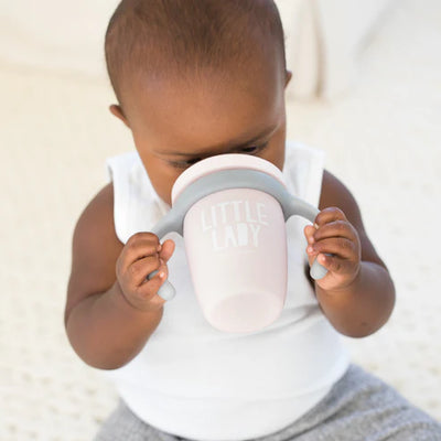 Bella Tunno Little Lady Happy Sippy Cup made of durable food-safe silicone with a soft spout, easy-grip handles, and a grow-with-me design to support your child's development.