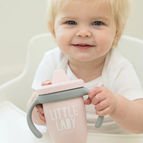 Bella Tunno Little Lady Happy Sippy Cup made of durable food-safe silicone with a soft spout, easy-grip handles, and a grow-with-me design to support your child&