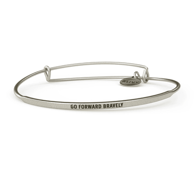 Silver bangle bracelet with the words "go forward bravely" engraved on it. 