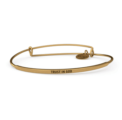 Gold bangle bracelet with the words "Trust in God" engraved on it.