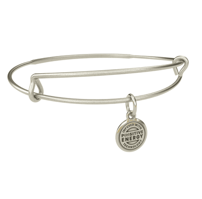 Silver bangle bracelet with a charm shaped like a dreamcatcher. The dreamcatcher is decorated with feathers and beads. 