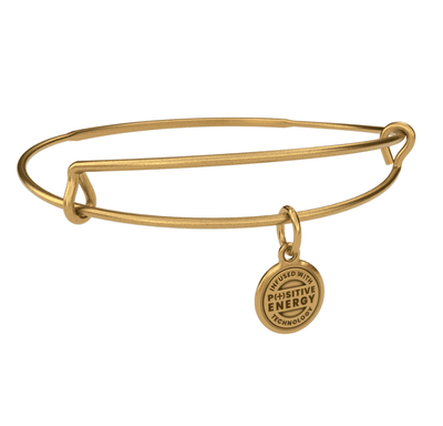Gold bangle bracelet with a gold charm. The charm is round and features the text “INFUSED WITH  POSITIVE ENERGY TECHNOLOGY”.