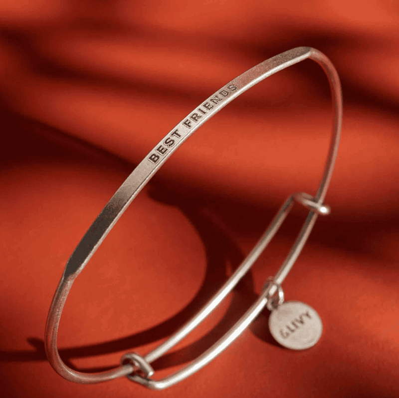 Silver bangle bracelet with the words "BEST FRIENDS" engraved on it.