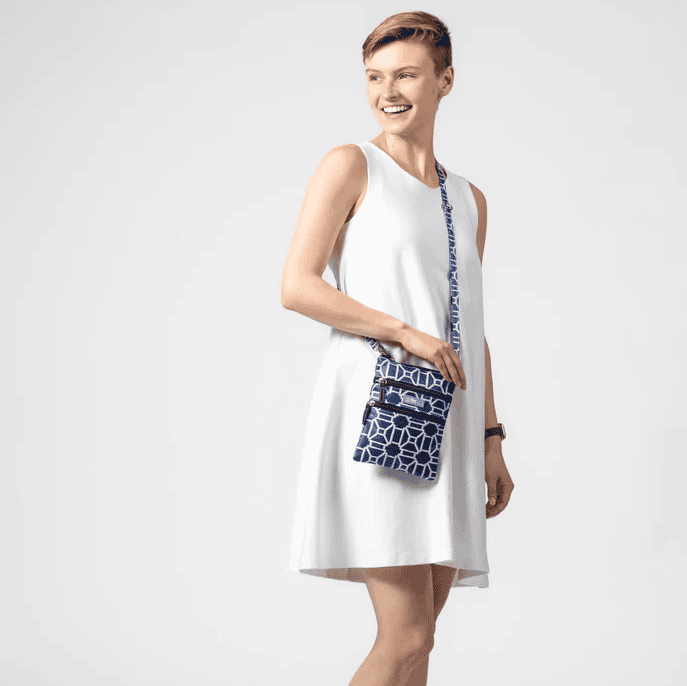 Black and white crossbody bag with geometric lattice pattern, three zippered compartments, and a detachable strap for hands-free use.