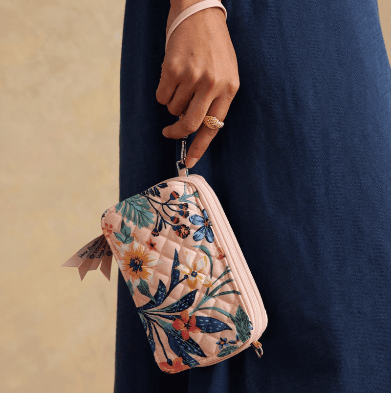 Vera Bradley RFID wallet crossbody in Paradise Coral with quilted cotton, multiple card slots, phone pocket, and zip closure.
