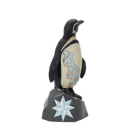  penguin standing on a rock with a star on it".