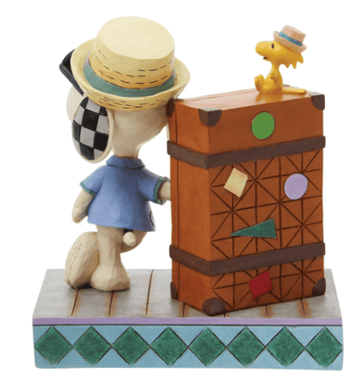 Jim Shore Snoopy and Woodstock vacation figurine with suitcase, Hawaiian shirt, and straw hats, hand-painted in folk art style.