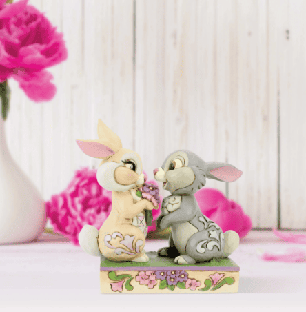 Jim Shore Disney figurine of Thumper and Miss Bunny falling in love, with Flower nearby, hand-painted in folk art style.