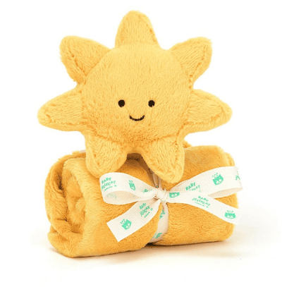 Smiling stuffed sun on yellow blanket