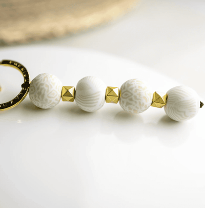 Ivory Palm 4-Ball Keychain with handcrafted 18mm clay beads, metal spacers, split ring, charm, and lobster-claw clip.