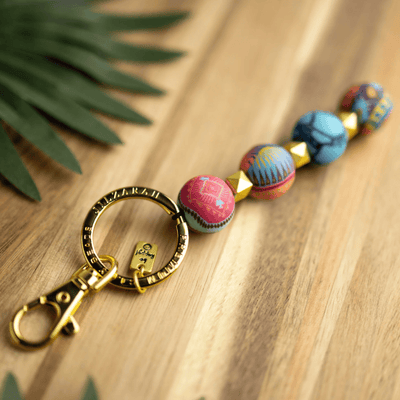 Sedona Sky 4-Ball Keychain featuring handcrafted clay beads, metal spacers, split keyring, charm, and lobster-claw clip.
