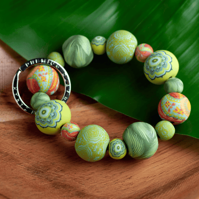 Green Fern Wrist Keychain with handcrafted polymer clay beads, durable elastic cord, and silver key ring featuring JILZARAH logo.
