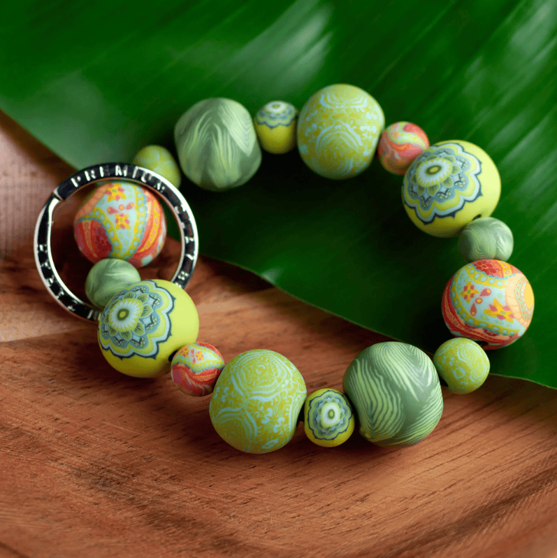 Green Fern Wrist Keychain with handcrafted polymer clay beads, durable elastic cord, and silver key ring featuring JILZARAH logo.