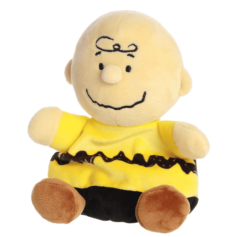 A small plush Charlie Brown doll with a round head and soft yellow shirt, part of the Palm Pals collection.