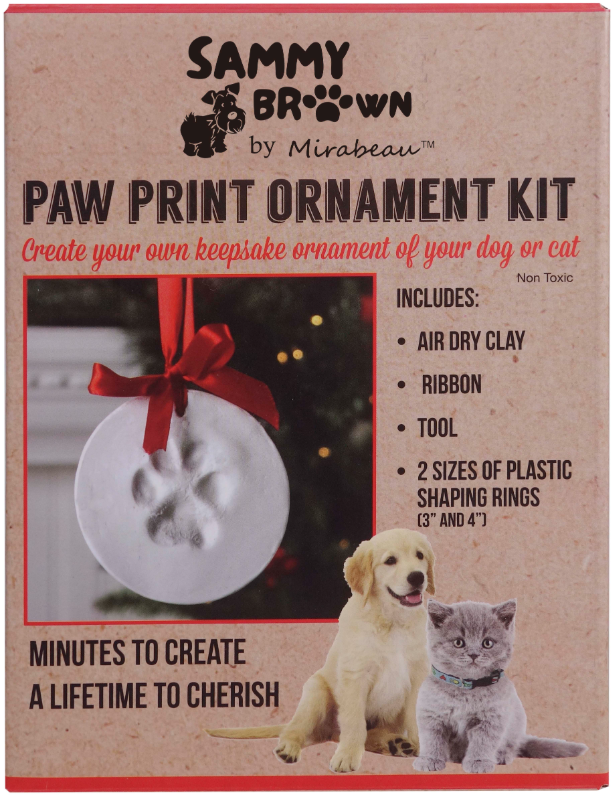 DIY paw print ornament kit with clay, ribbon, tools, and packaging showing a dog and cat.