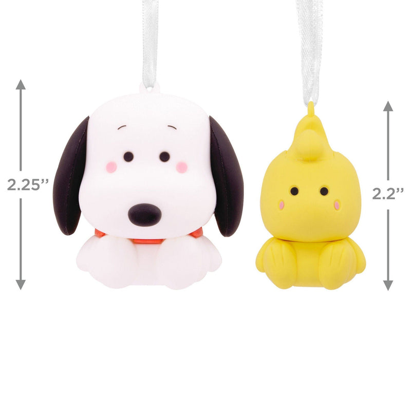 Set of two Snoopy and Woodstock Christmas ornaments. Snoopy, a small beagle dog, is wearing a Santa hat. Woodstock, a small yellow bird, is perched on Snoopy’s head
