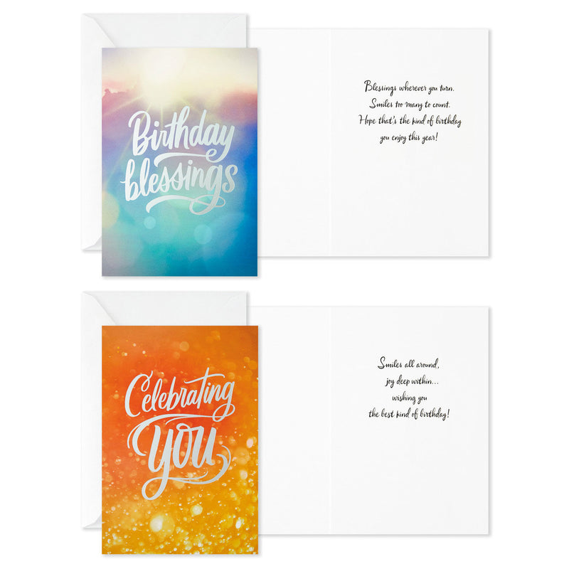 Boxed birthday cards with colorful soft-focus backgrounds, script lettering, silver foil accents, and envelopes, four bright cheerful designs.
