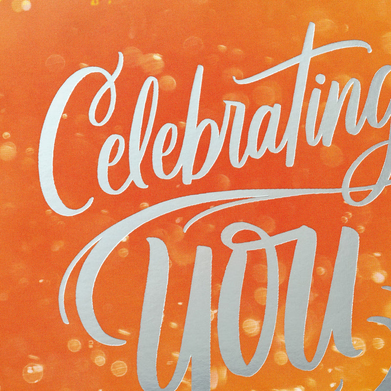 Boxed birthday cards with colorful soft-focus backgrounds, script lettering, silver foil accents, and envelopes, four bright cheerful designs.
