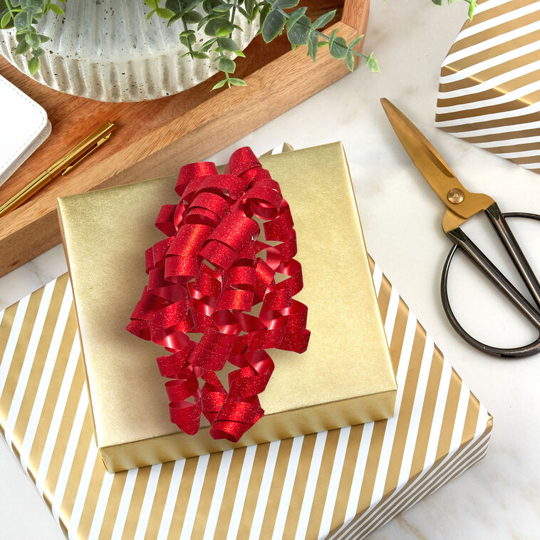 Hallmark red curly ribbon gift bow with glittery finish and self-adhesive backing, featuring cascading red curls for gift wrapping.