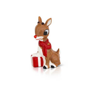 Official Rudolph the Red-Nosed Reindeer mini from Nora Fleming, featuring Santa’s famous reindeer with a red nose for festiv
