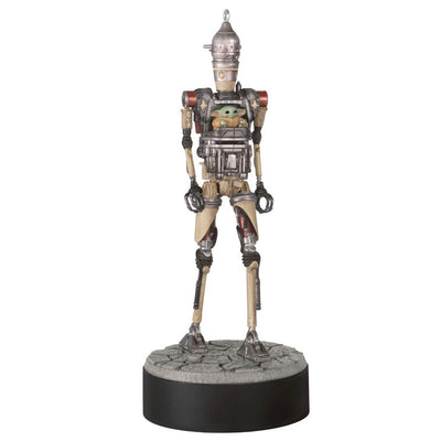Ornament of Grogu piloting IG-12 droid from Star Wars: The Mandalorian™, on round base with sound button for “Yes” and “No” phrases.