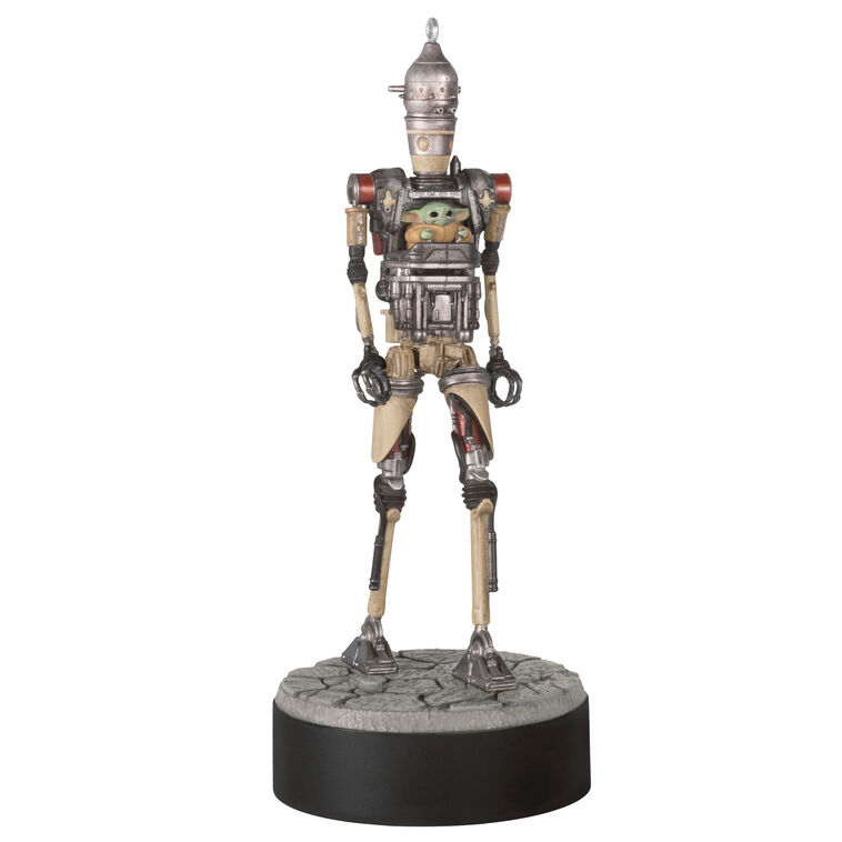 Ornament of Grogu piloting IG-12 droid from Star Wars: The Mandalorian™, on round base with sound button for “Yes” and “No” phrases.