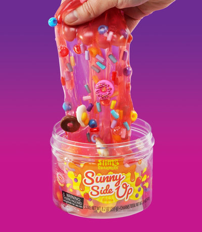 Crazy Aaron’s Sunny Side Up red slime with egg, donut, and croissant charms for fun sensory play that’s squishy, stretchy, and savory-sweet