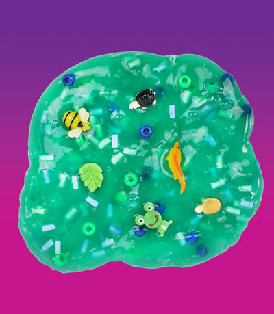 Crazy Aaron’s Swamp Water slime with fish and creature charms in dark green slime for squishy, stretchy, sensory swamp play