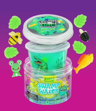 Crazy Aaron’s Swamp Water slime with fish and creature charms in dark green slime for squishy, stretchy, sensory swamp play