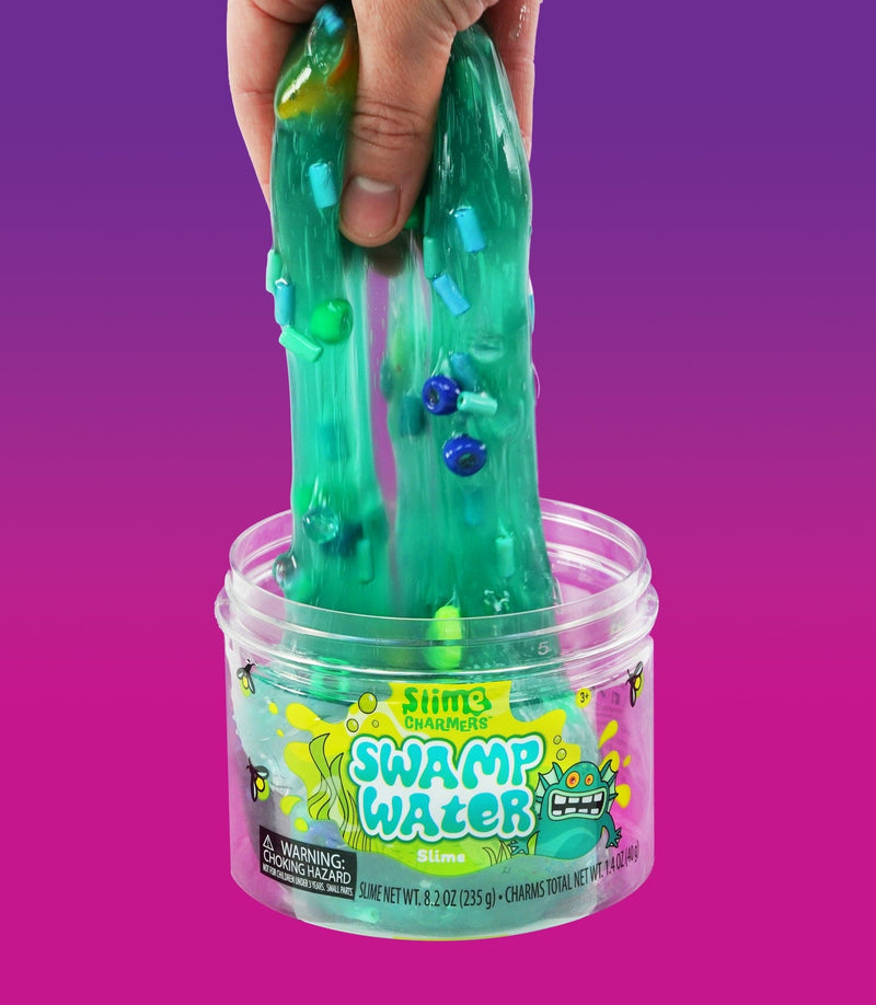 Crazy Aaron’s Swamp Water slime with fish and creature charms in dark green slime for squishy, stretchy, sensory swamp play