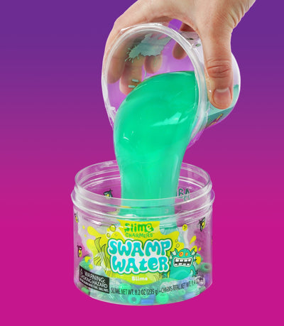 Crazy Aaron’s Swamp Water slime with fish and creature charms in dark green slime for squishy, stretchy, sensory swamp play