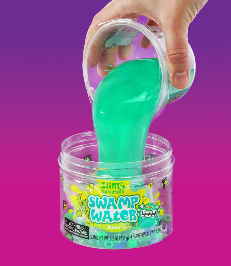 Crazy Aaron’s Swamp Water slime with fish and creature charms in dark green slime for squishy, stretchy, sensory swamp play