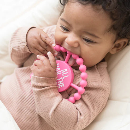 Circular silicone baby teether with "All Hail the Queen" phrase, textured edge, easy to grip and chew for teething relief.