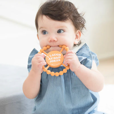Round silicone teether with "I Laugh at Dad Jokes" text, beaded edge for teething relief, perfect for baby grip and chewing.