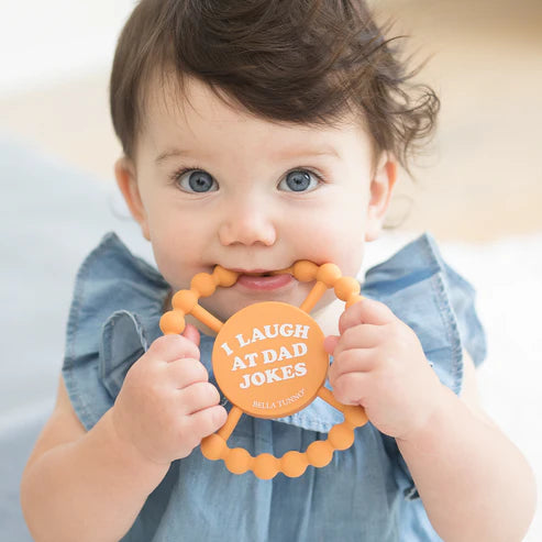 Round silicone teether with "I Laugh at Dad Jokes" text, beaded edge for teething relief, perfect for baby grip and chewing.
