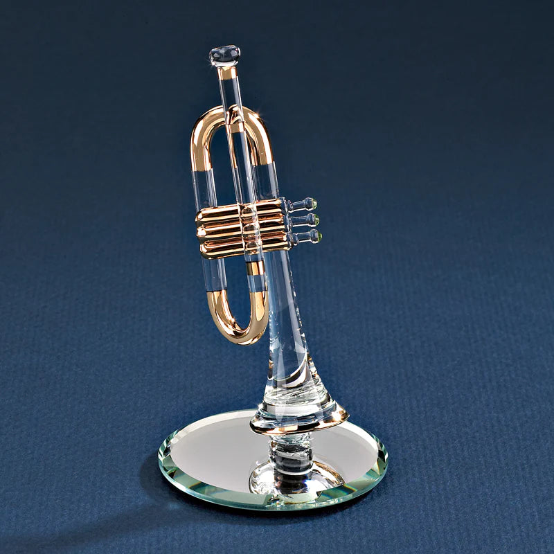 Glass trumpet figurine with 22Kt gold and crystal accents, displayed on a beveled mirror base.