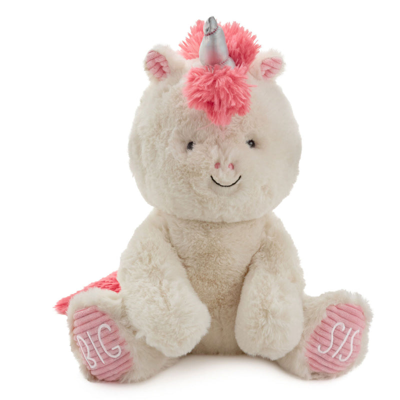 Big Sister unicorn plush toy with white fur, pink corduroy feet, coral mane, and stitched “Big Sis” lettering