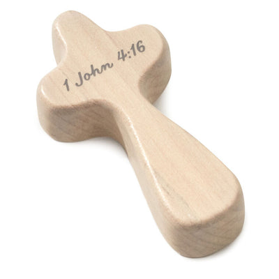 Hallmark mini comfort cross with gray heart design and I John 4:16 Bible verse on light wood.
