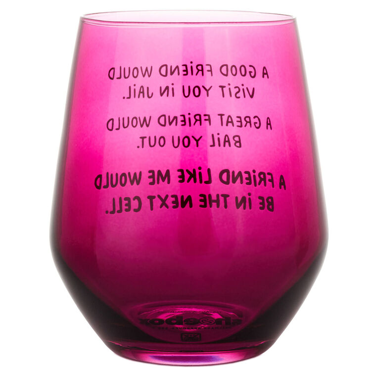 Dark berry-tinted stemless wine glass with white text: “A good friend would visit you in jail.