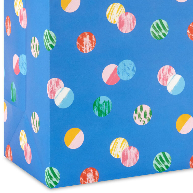 Hallmark extra-large gift bag with playful polka dots on a blue background, ideal for birthdays, holidays, or celebrations.